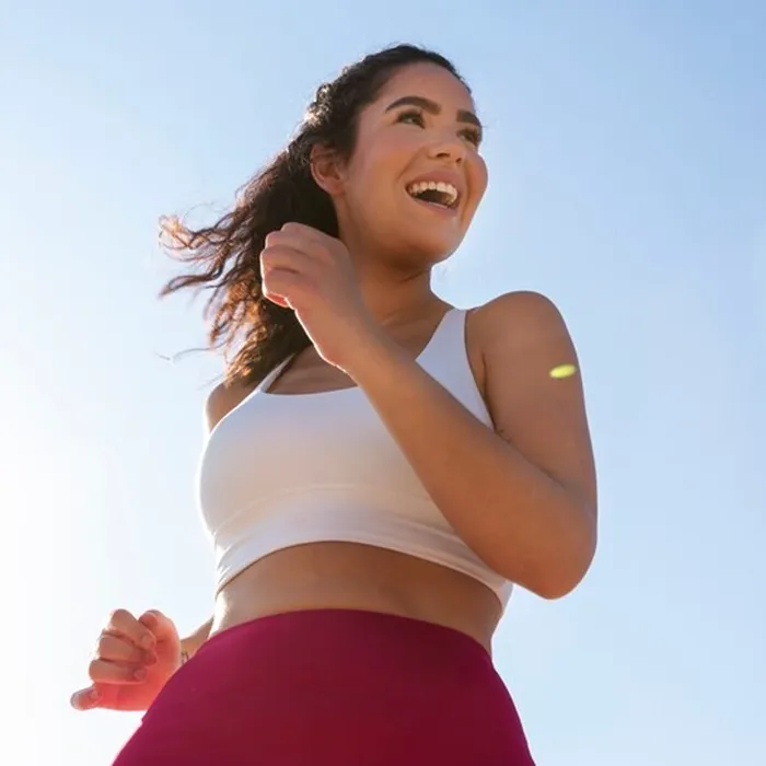 Smiling woman jogging outdoors
