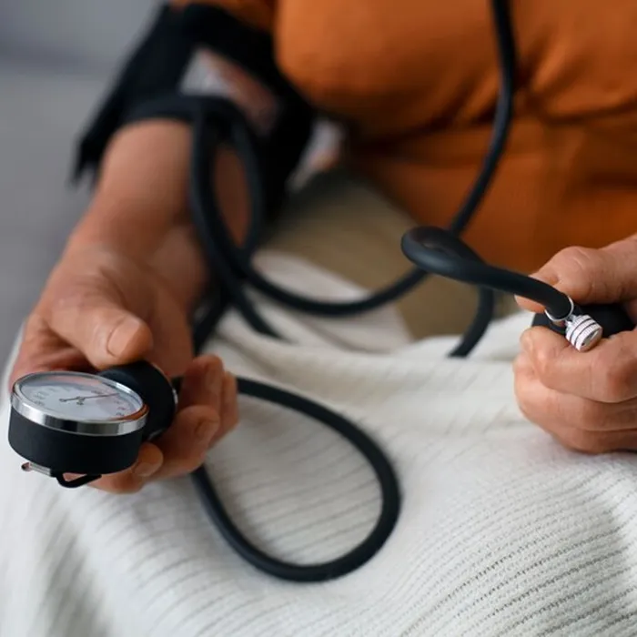 Person using a home blood pressure monitor